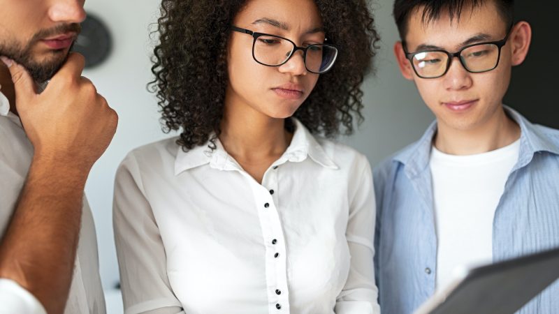 Serious diverse programmers using tablet